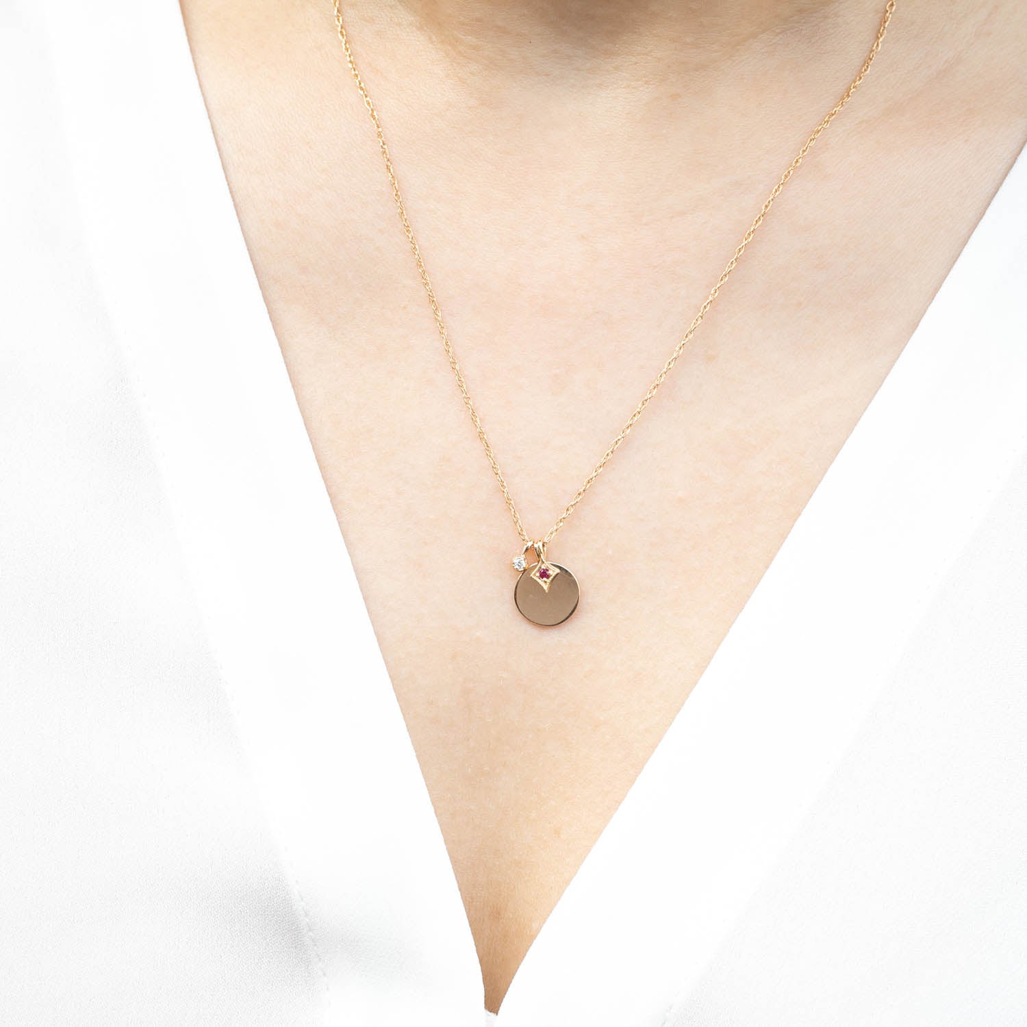 Delicate Birthstone Dahlia Charm necklace in solid 14k gold with an ethically sourced gemstone, shown worn casually.