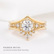 Close-up of Ivy Ring in ethically sourced solid gold with intricate diamond detailing on a soft white fabric background