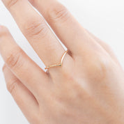 Ivy Ring on a hand, featuring a delicate 1.5mm ethically sourced solid gold band by Envero Jewelry