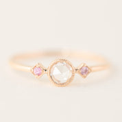 Rose gold Moon & Star ring with a rose-cut diamond center and two accent pink gemstones in milgrain bezel setting