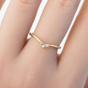 Solid gold triple star accent ring with natural white diamonds worn on a finger, packaged in recyclable kraft box