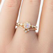 Close-up of a hand wearing a star accent ring with natural white diamonds set in ethically sourced solid gold band