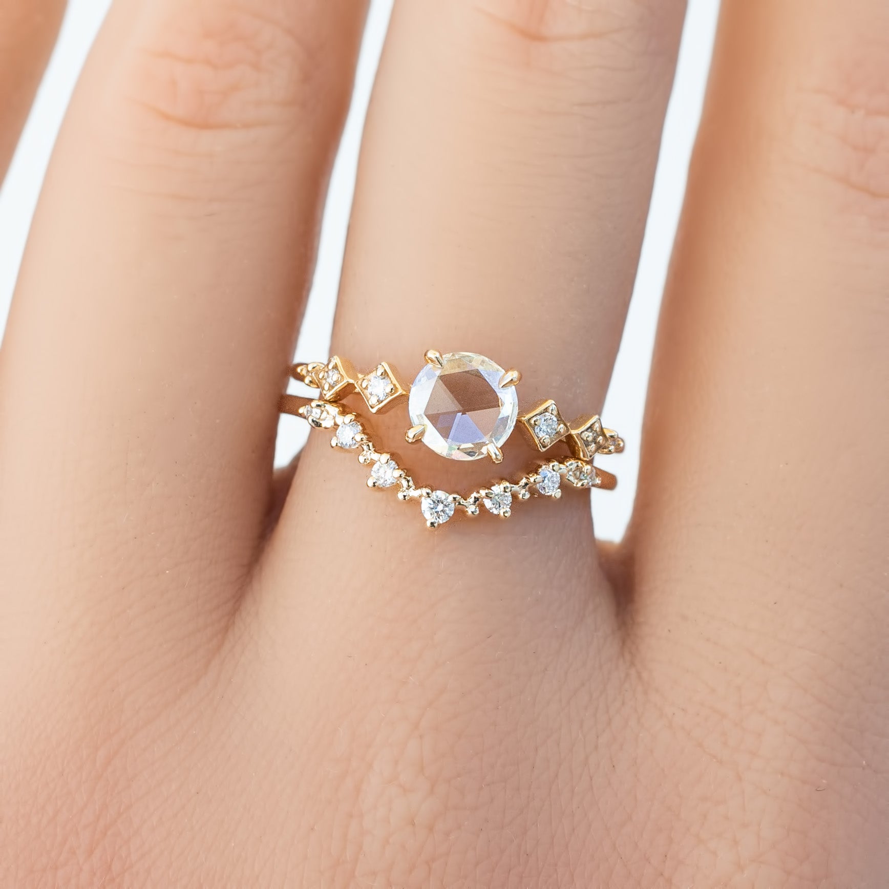 Close-up of hand wearing Norah Tiara Ring with natural diamonds set in ethically sourced solid gold