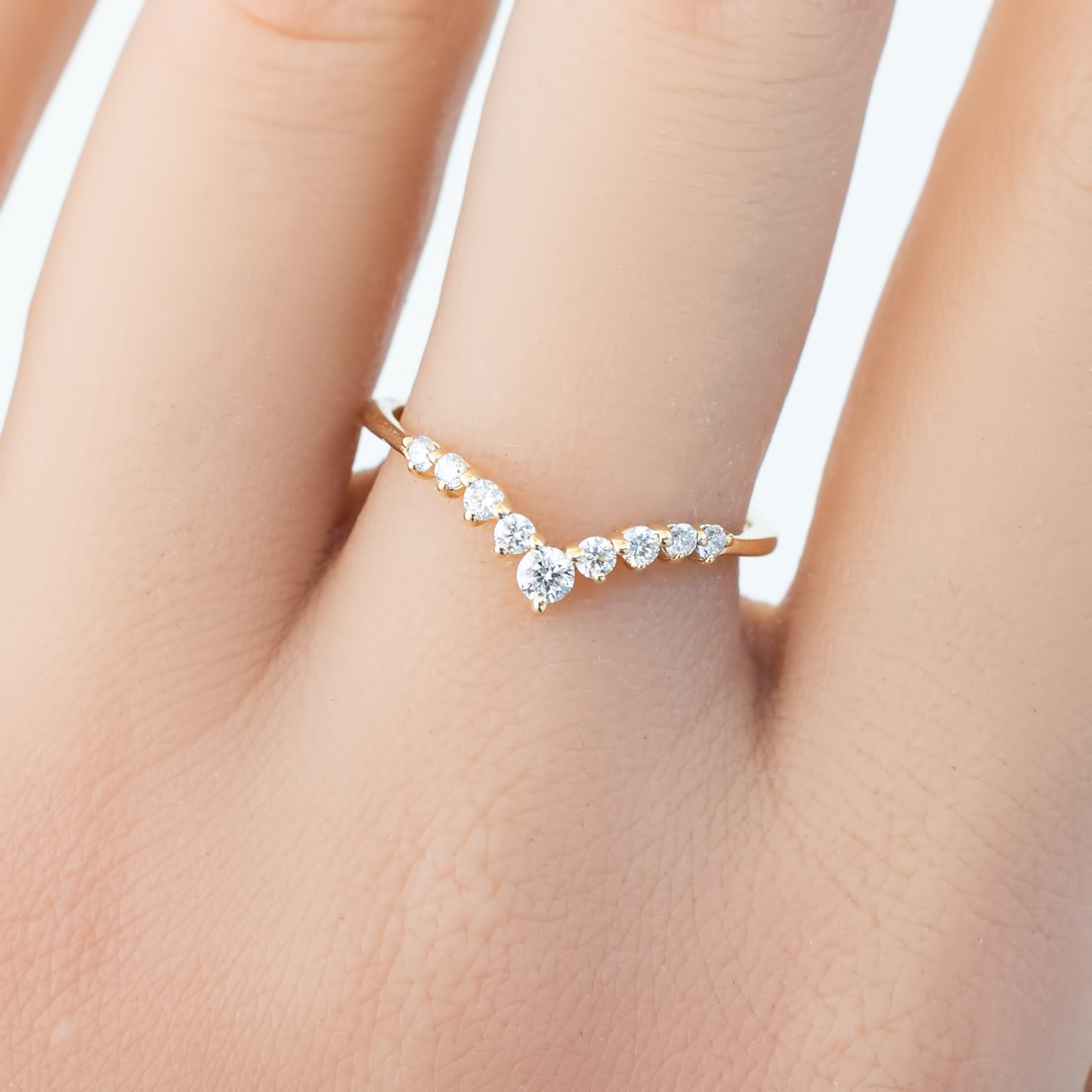 Lily's Tiara Ring with natural white diamonds in an ethically sourced solid gold band, worn on a hand.