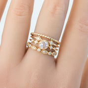 Hand wearing Tia Half-Eternity Ring in solid gold with natural white diamonds, detailed band design, recyclable box included