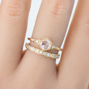 Close-up of gold Eva Ring with natural white diamonds on a finger, showcasing half-eternity and art deco style.