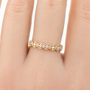 Milgrain hexagon ring with natural white diamonds set in ethically sourced solid gold on a finger
