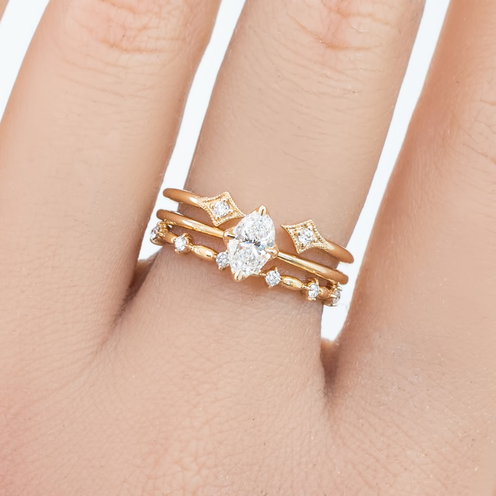 Distant Star Ring featuring natural white diamonds set in ethically sourced solid gold on a hand model.