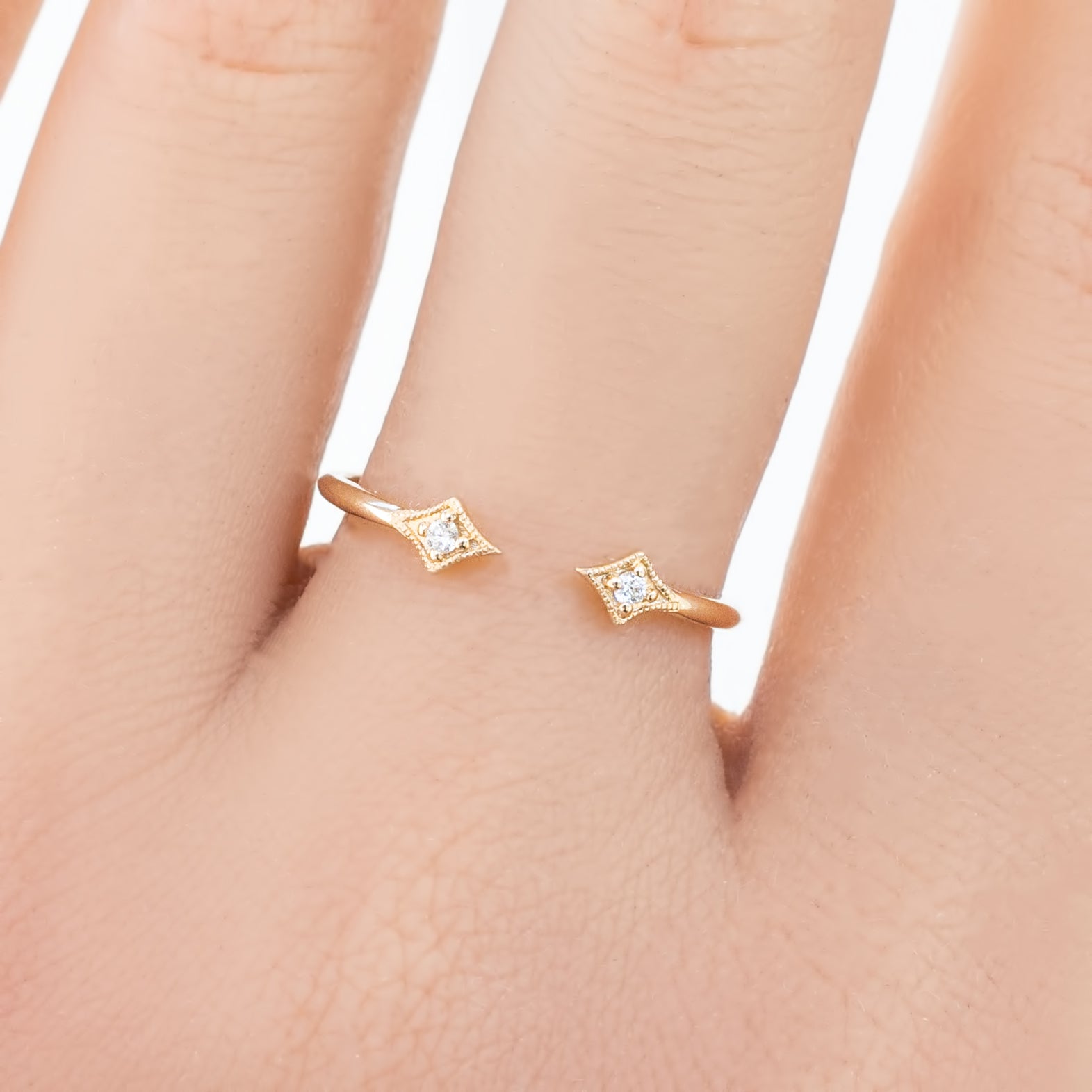 Double Star Diamond Open Ring in solid gold with two brilliant cut white diamonds on a hand, minimalist design.