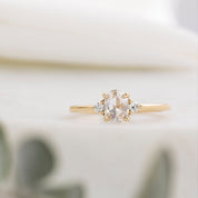 Gold ring with a diamond on a blurred background