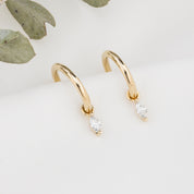 Gold hoop earring with measurements of appx 13.5mm diameter on a white background