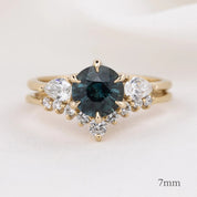 Lily's Tiara Ring featuring a 7mm deep blue center gemstone with ethically sourced gold and white diamonds
