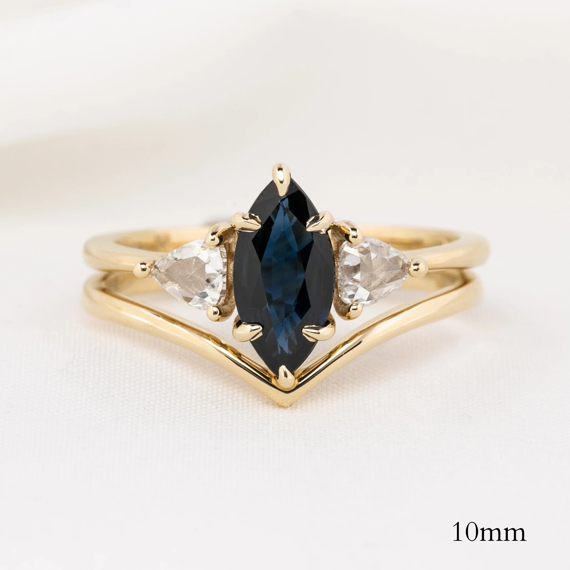 Ivy Ring with marquise blue gemstone and two clear stones in ethically sourced solid gold band