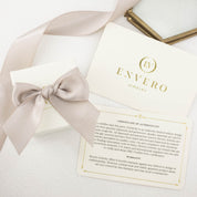 white square kraft jewelry box with pink ribbon, oval shape gemstone