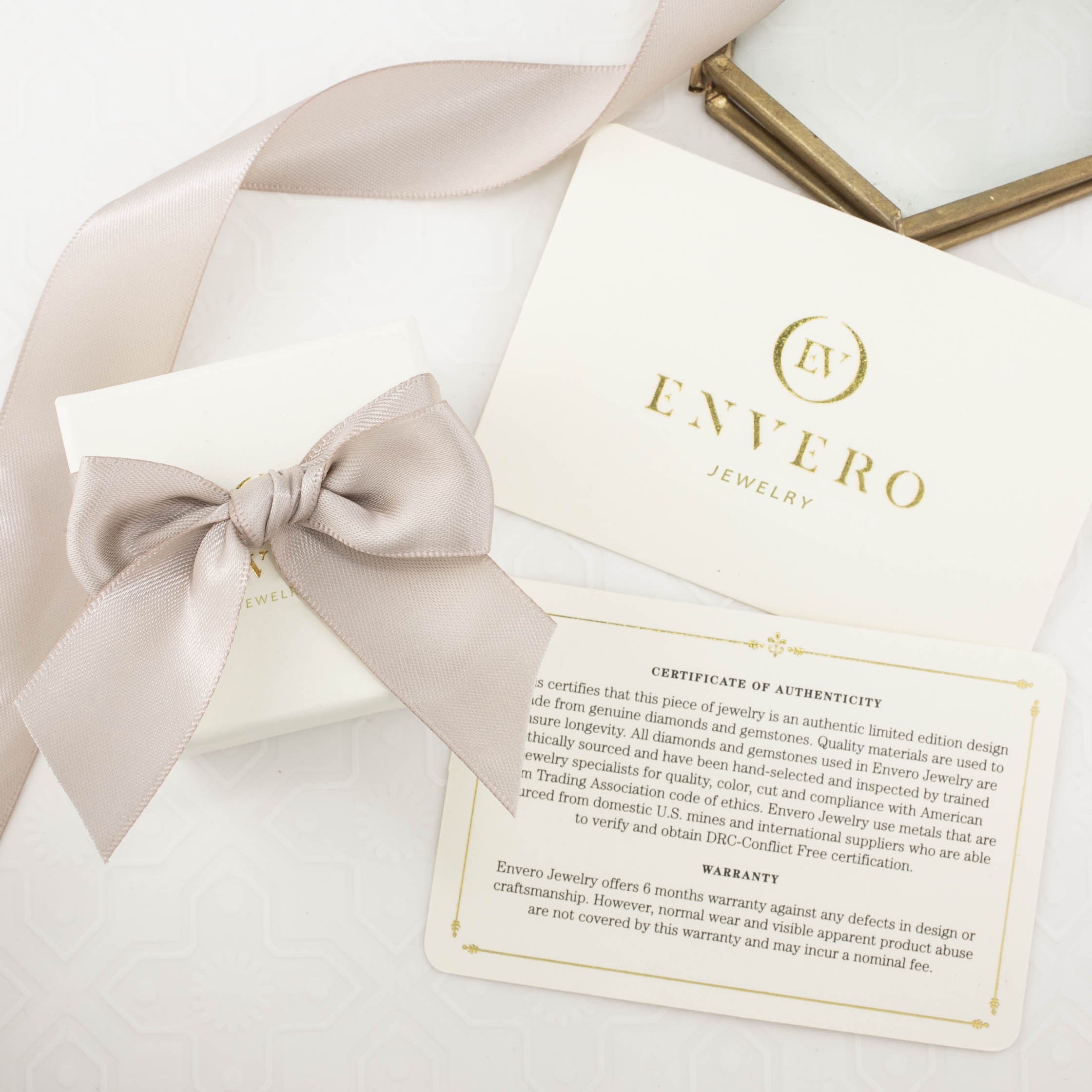 white square kraft jewelry box with pink ribbon, oval shape gemstone