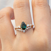 Lily's Tiara Ring featuring a pear-shaped green gemstone with sparkling diamonds in ethically sourced gold band