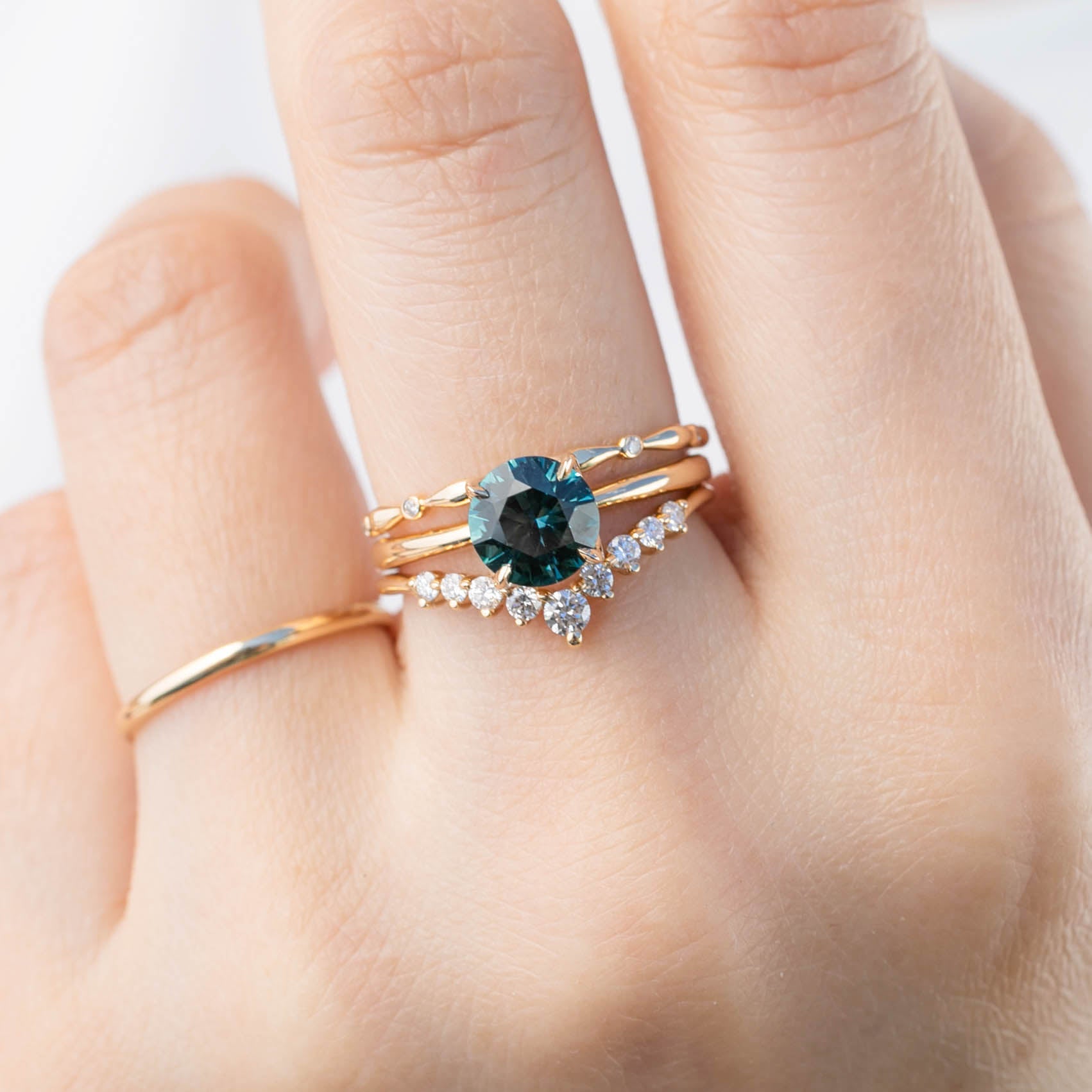 Lily's Tiara Ring featuring natural white diamonds and ethically sourced solid gold on a hand display.