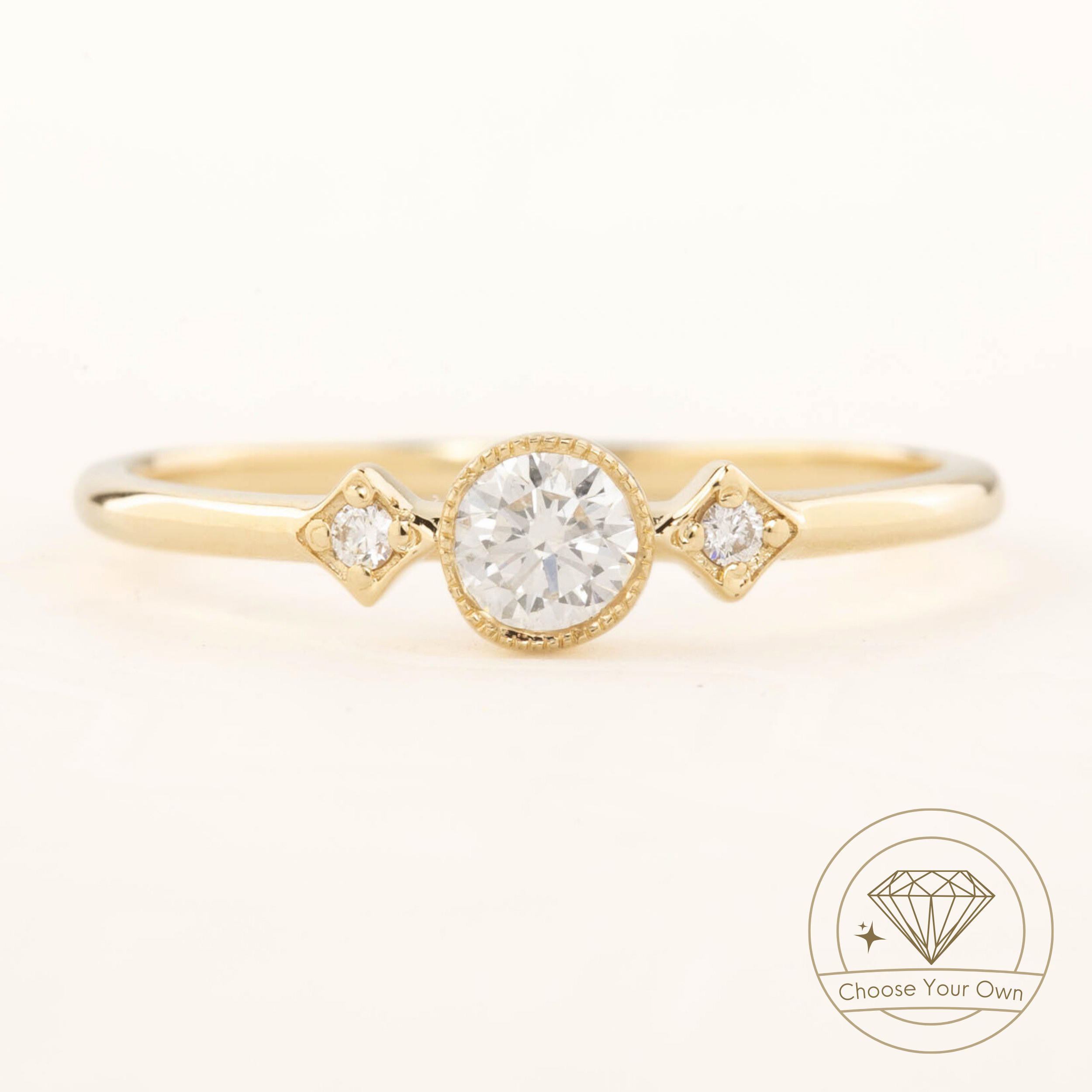 Gold Moon & Star ring with a 0.3ct brilliant-cut diamond and two small accent diamonds in milgrain bezel setting