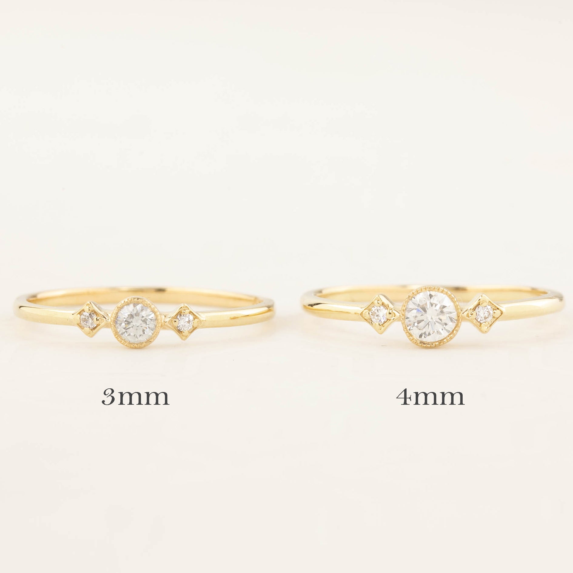 Two gold Moon & Star rings with brilliant cut diamonds, sized 3mm and 4mm, milgrain bezel setting on bands