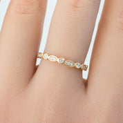 Delicate Seren Ring with natural white diamonds set in ethically sourced solid gold band on finger close-up