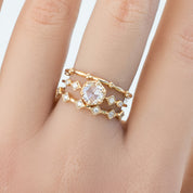 Gold Six Star Ring with natural white diamonds on finger in recyclable kraft box packaging
