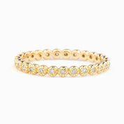 Dahlia Diamond Eternity Ring in solid gold with bezel-set white diamonds in a full circle design, recycled kraft box included.