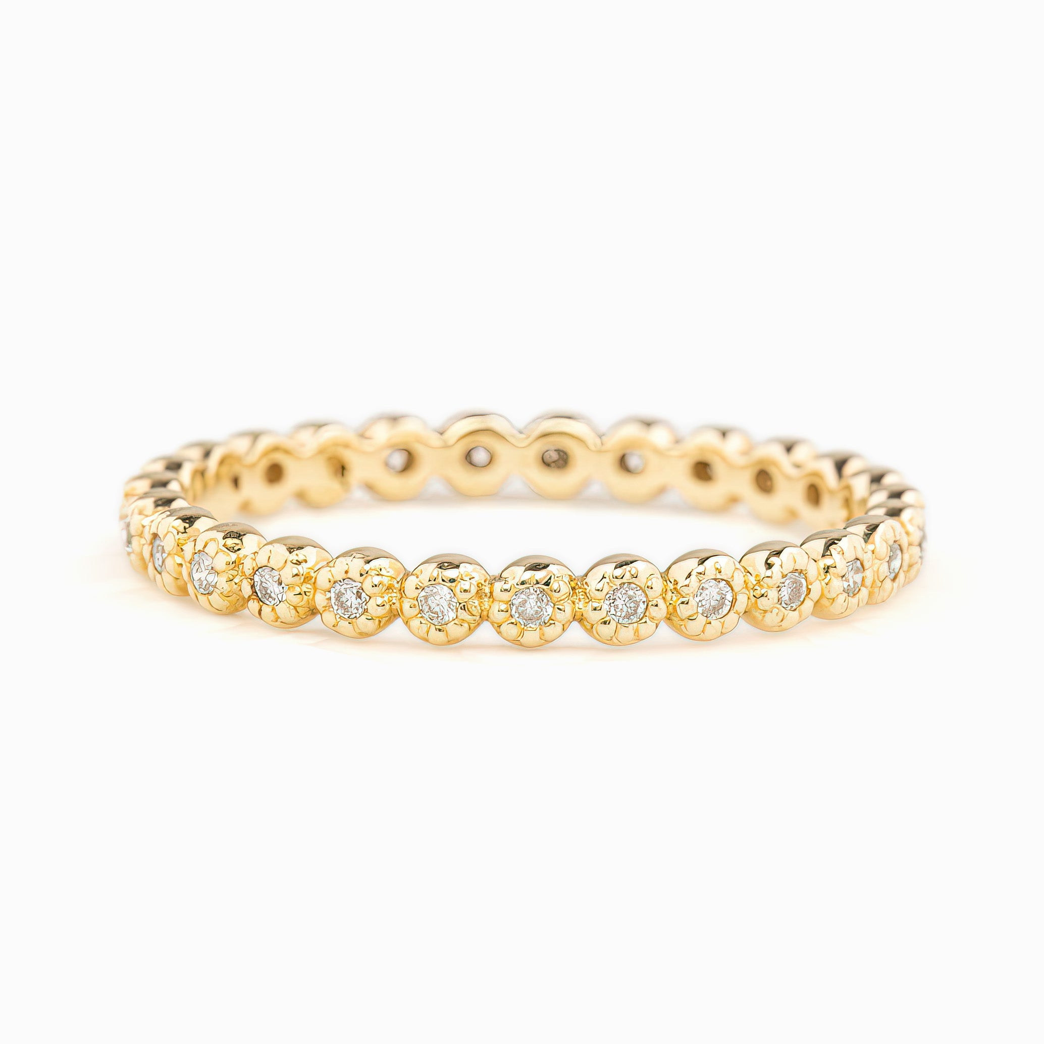 Dahlia Diamond Eternity Ring in solid gold with bezel-set white diamonds in a full circle design, recycled kraft box included.