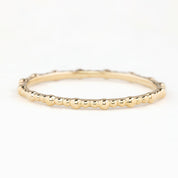 Solid gold full eternity bead ring with 1.5mm band width, ethically sourced, shown on white background.