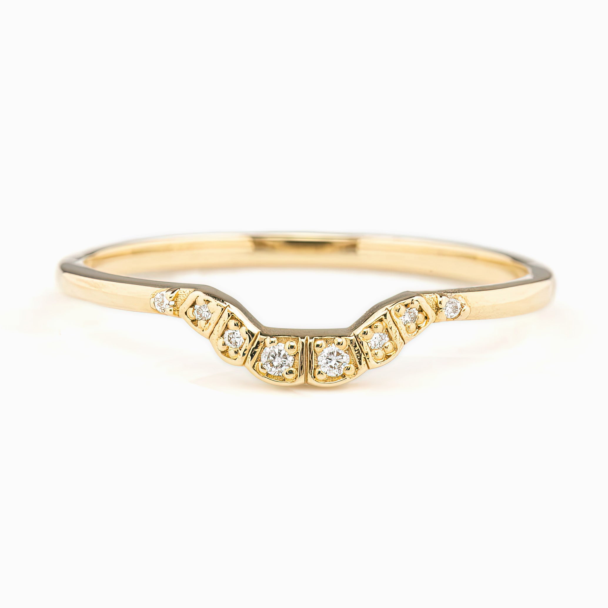 Curved solid gold ring with natural white diamonds set in a U-shaped band, ethically sourced and elegant design