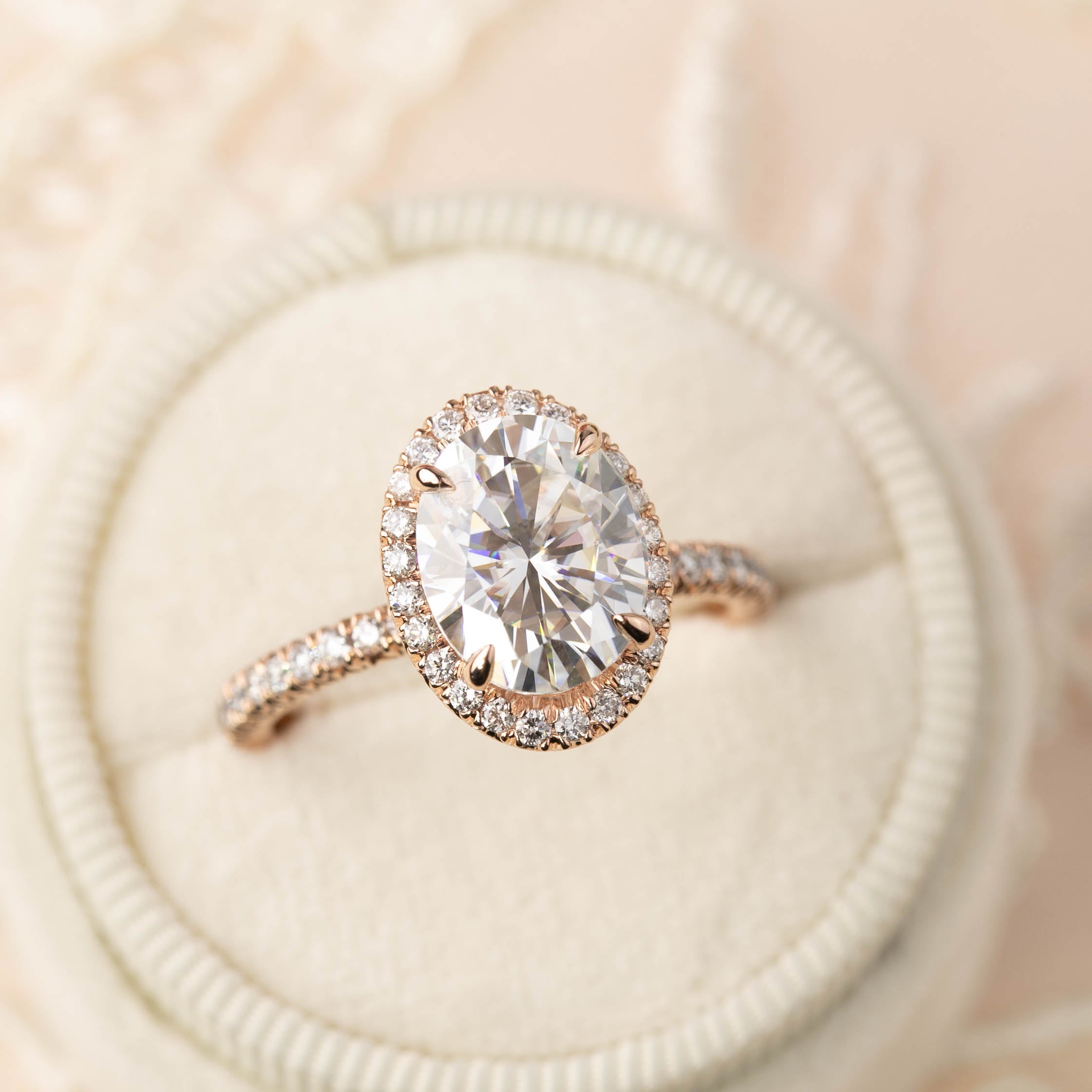 3ct certified Neo Moissanite halo ring with rose gold half-eternity band and French cut down setting details.