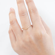 Hand wearing an ethically sourced solid gold Ivy Ring with a delicate 1.5mm band by Envero Jewelry