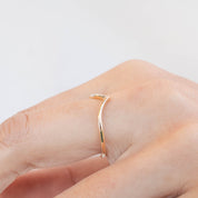 Close-up of a handmade Ivy Ring in solid gold, ethically sourced and worn on a finger, packaged in recyclable kraft box