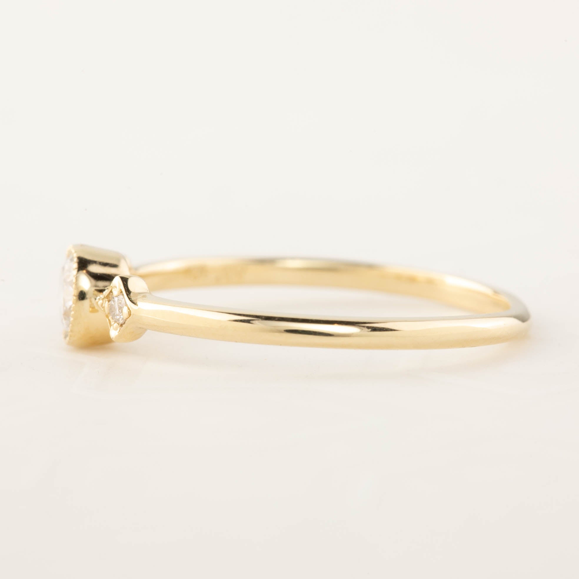 Delicate gold Moon & Star ring with a brilliant-cut diamond and milgrain bezel setting on a thin band