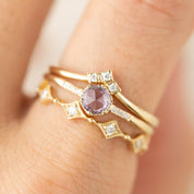 Close-up of a Triple Star Accent Ring in solid gold with natural white diamonds on a finger