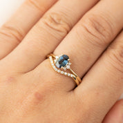 Esperanza Ring with natural white diamonds and a blue gemstone set in ethically sourced solid gold band on finger