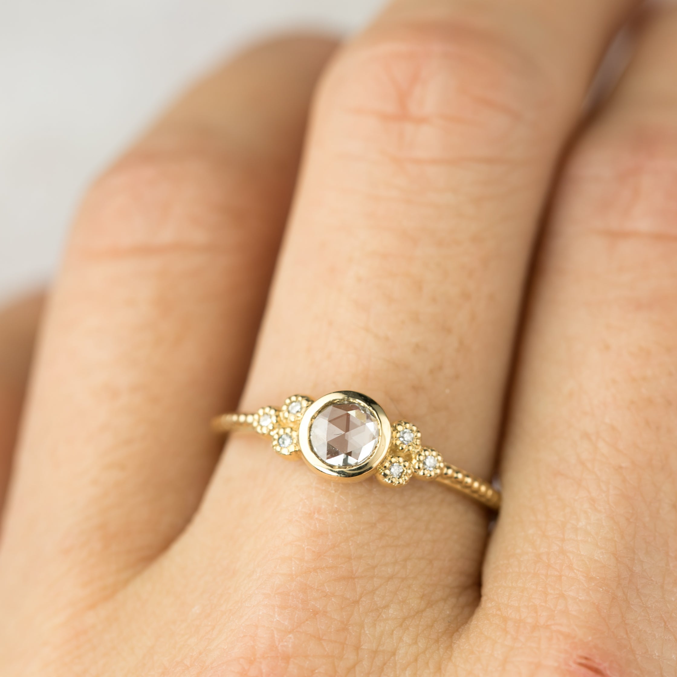 Elegant Faye Ring with 4mm rose cut diamond and six decorative melee diamonds in 14k yellow gold band.
