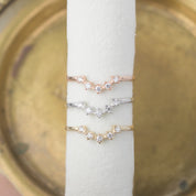 Three star tiara rings in rose gold, silver, and yellow gold with natural white diamonds on a white display.