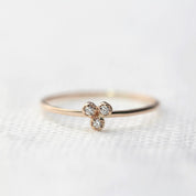Dahlia Trio Diamond Ring with three bezel-set white diamonds on a thin recycled gold band for stacking.