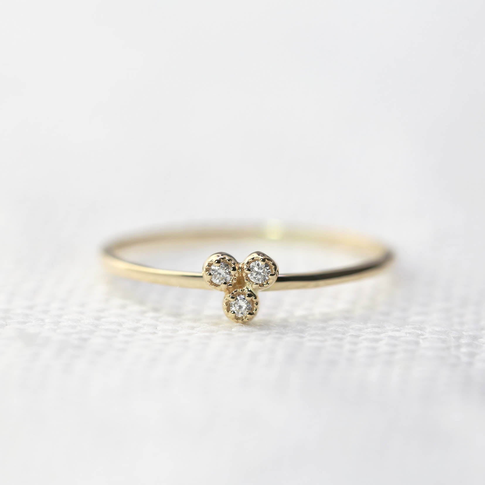 Dahlia Trio Diamond Ring with three brilliant white diamonds set on a thin recycled gold band, ideal for stacking.