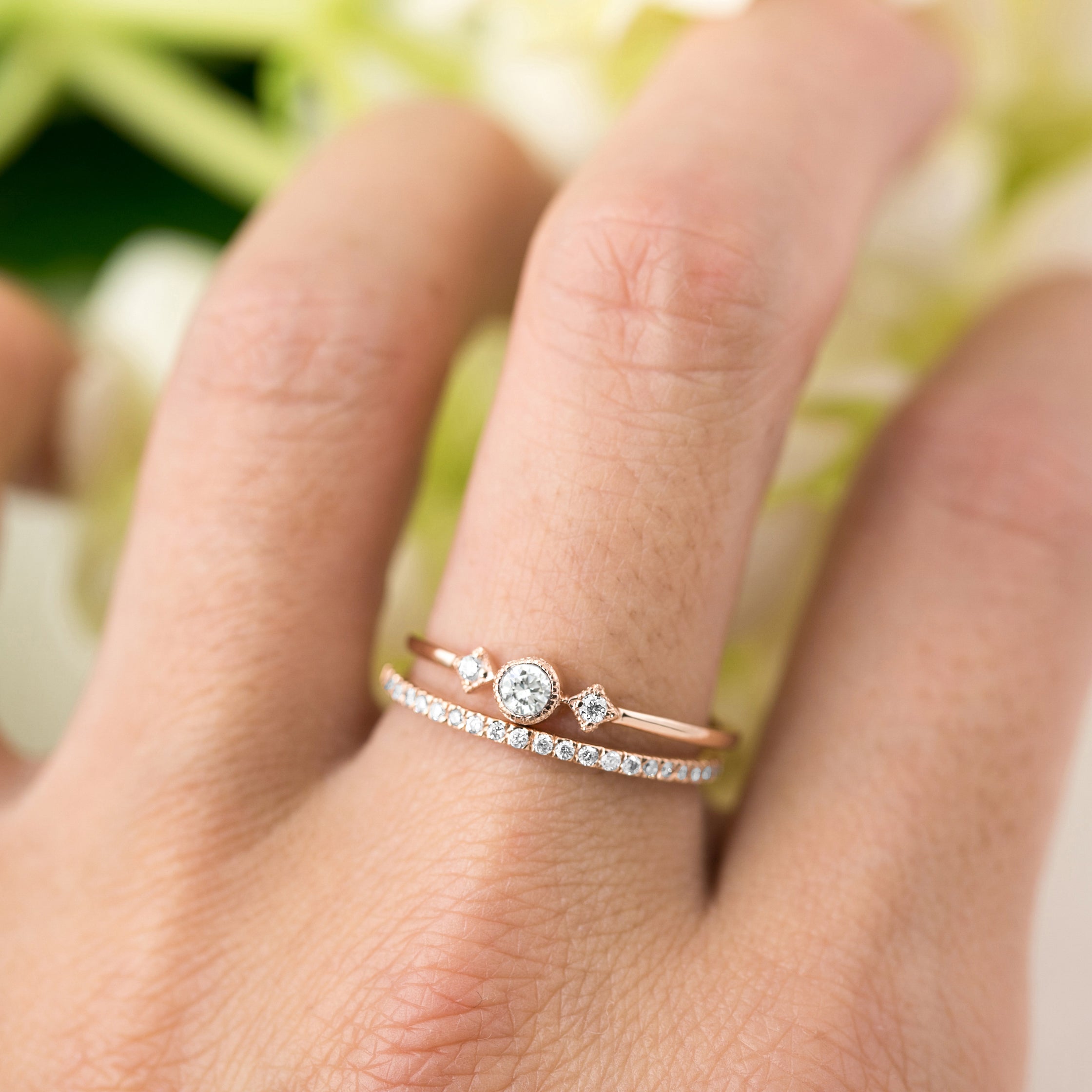 Close-up of a hand wearing a rose gold Moon & Star Ring with a brilliant-cut diamond and smaller accent diamonds