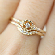 Close-up of Isabel’s Curved Ring in solid gold with natural white diamonds in a delicate U-shaped band design