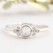 Close-up of Faye Ring featuring a 4mm rose cut diamond with six smaller diamonds on a delicate white gold band