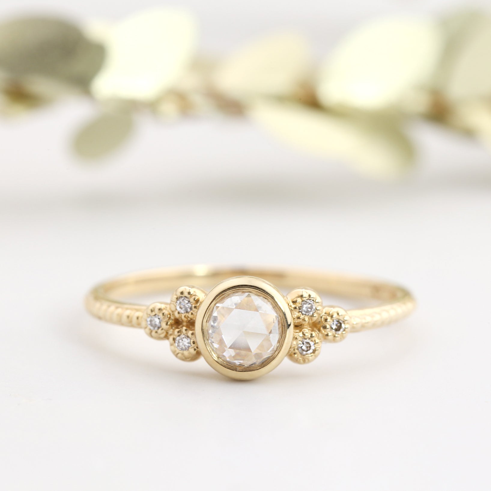 14k gold engagement ring with 0.3ct rose cut diamond and six small accent diamonds on a slender band
