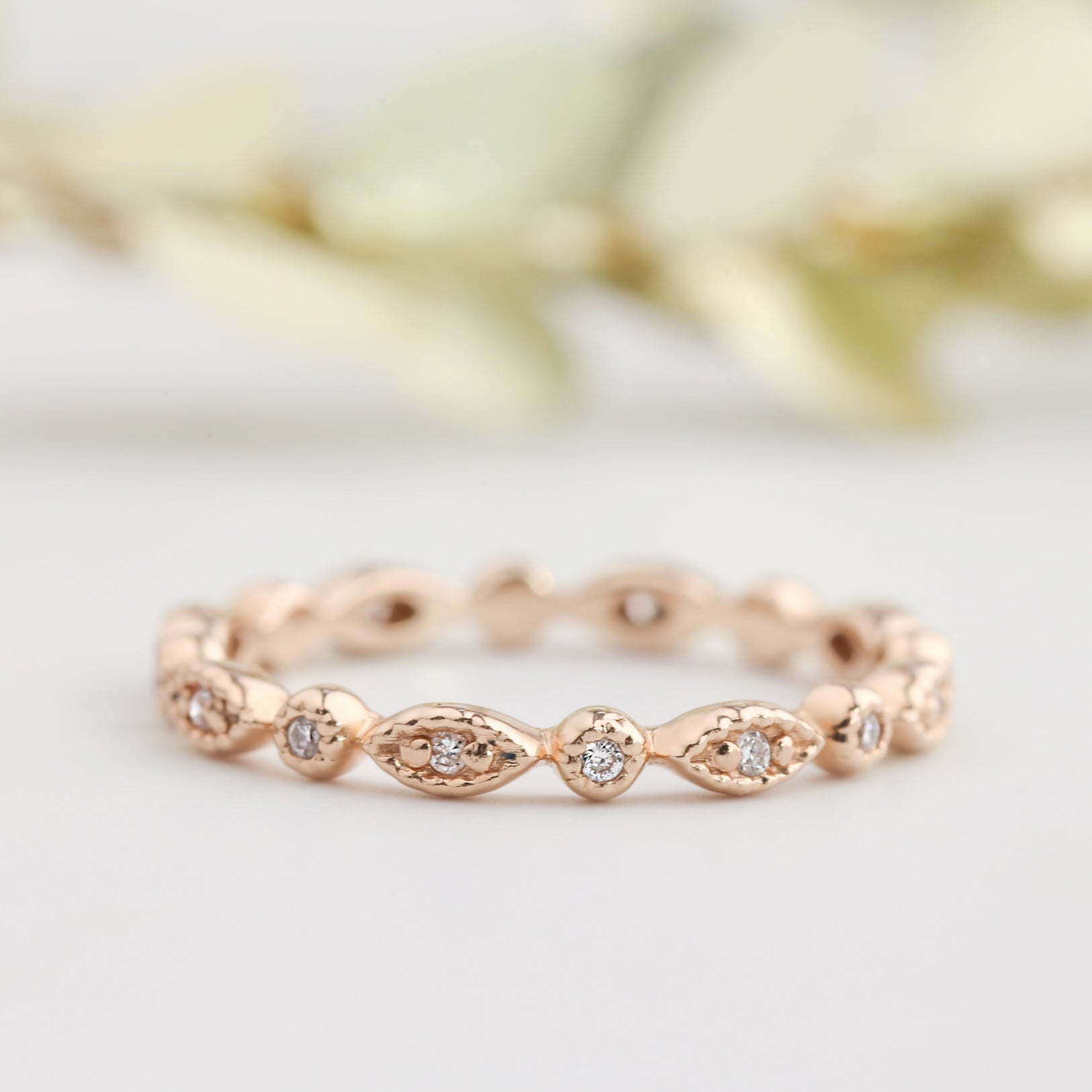Rose gold Tia Petite Half Eternity Ring with milgrain detail and natural white diamonds, art-deco inspired design.