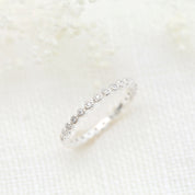 Dahlia Diamond Eternity Ring with natural white diamonds set in a delicate bezel setting on a slim band.