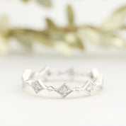 Close-up of a Star Diamond Eternity Ring with white diamonds set in ethically sourced solid gold band