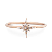 Rose gold starburst diamond ring with brilliant cut diamonds on a delicate 14k gold band