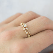 Elegant six star ring with natural white diamonds set in ethically sourced solid gold on finger