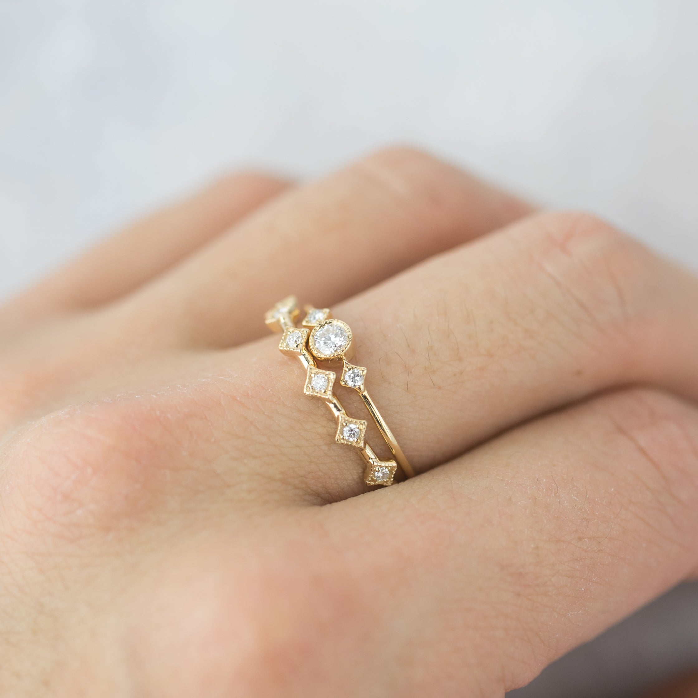 Elegant six star ring with natural white diamonds set in ethically sourced solid gold on finger