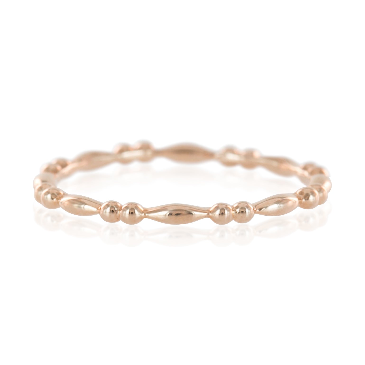 Rose gold beaded stacking ring with unique rounded and elongated beads, 1.5mm band width, polished finish.